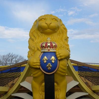 ...tenant un blason a 3 fleurs de lys entre ses pattes